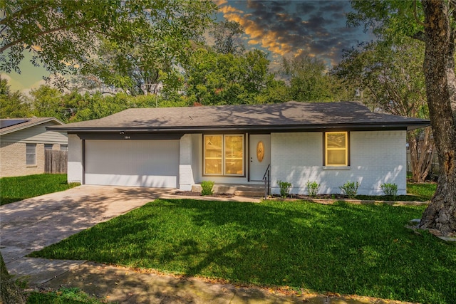 1504 Nichols St, Ennis, TX 75119 - view of front facade featuring brick siding, driveway, a garage, and a front yard