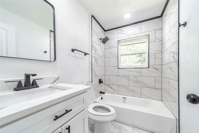 full bathroom featuring vanity, tiled shower / bath combo, and toilet