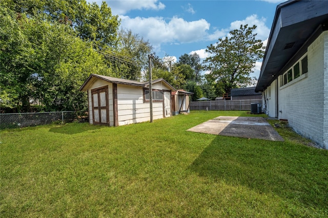 view of yard with a storage unit, central air condition unit, and a patio area