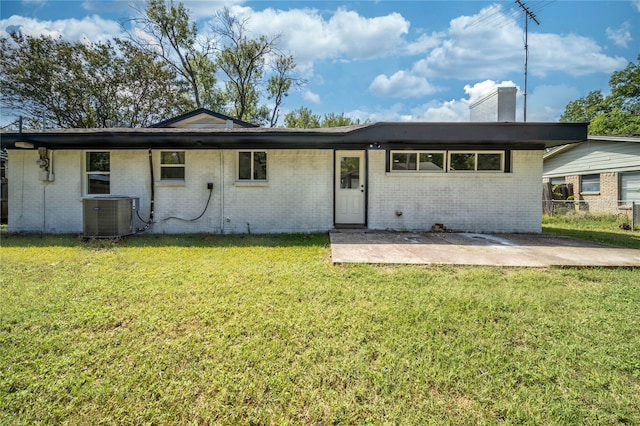 back of house featuring a yard, a patio area, and central AC