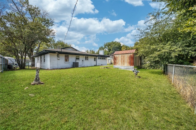 view of yard with a storage shed and central AC