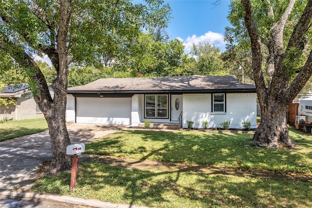 ranch-style home with a front yard and a garage