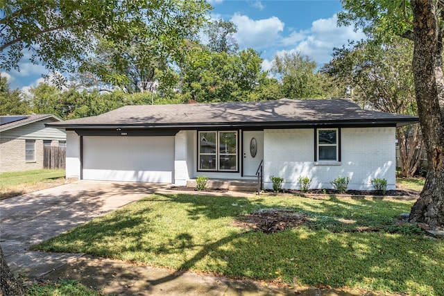 ranch-style home featuring a garage and a front lawn