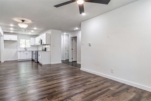 unfurnished living room with ceiling fan, sink, and dark hardwood / wood-style flooring