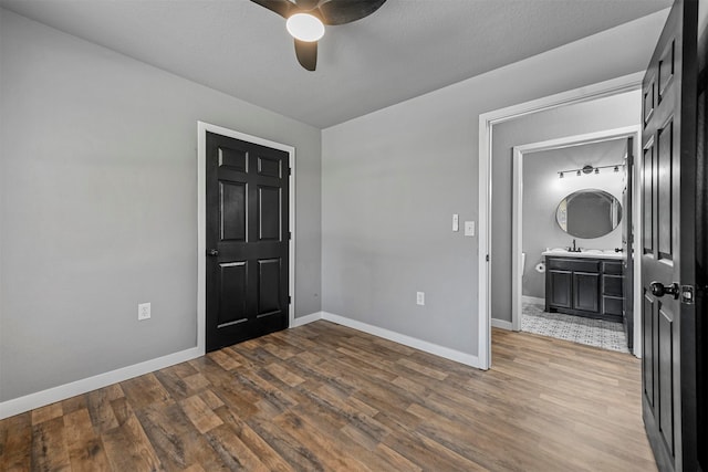 interior space with a textured ceiling, hardwood / wood-style floors, and ceiling fan