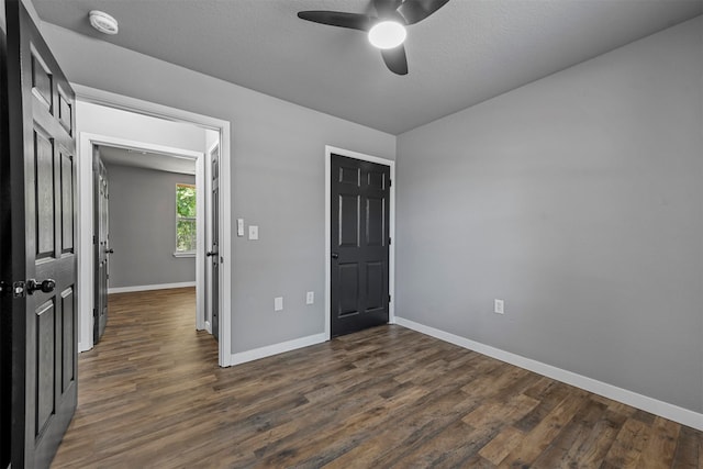 unfurnished bedroom featuring a textured ceiling, dark hardwood / wood-style floors, and ceiling fan