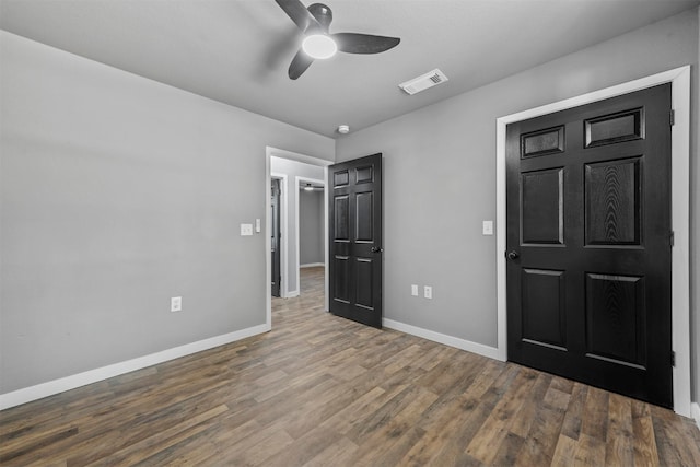 unfurnished bedroom with ceiling fan and hardwood / wood-style floors