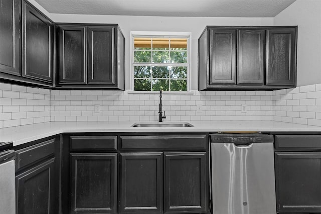 kitchen with backsplash, sink, and stainless steel dishwasher