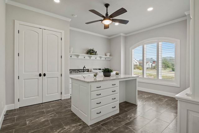 interior space featuring white cabinets, ceiling fan, and crown molding