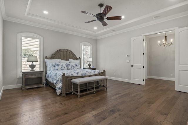 bedroom featuring ceiling fan with notable chandelier, dark wood-type flooring, baseboards, and crown molding