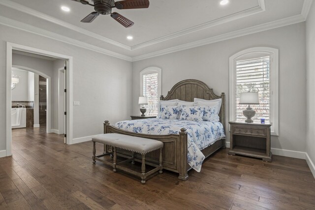 bedroom with ornamental molding, ceiling fan, a raised ceiling, and dark wood-type flooring