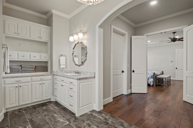 bathroom with vanity, ceiling fan, hardwood / wood-style floors, and crown molding