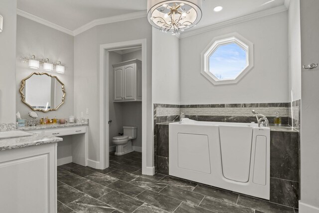 bathroom featuring a bathtub, ornamental molding, vanity, and toilet