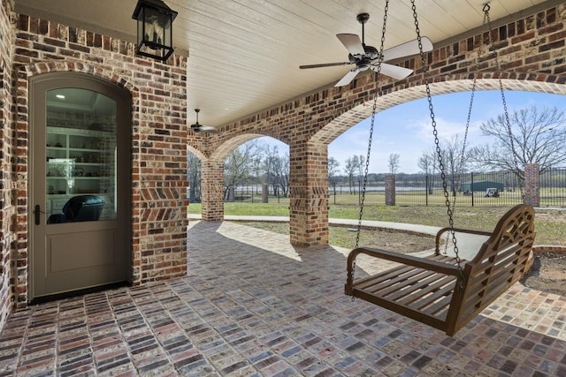 view of patio featuring fence and a ceiling fan