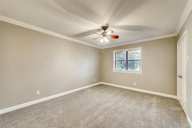 carpeted empty room featuring ceiling fan and crown molding