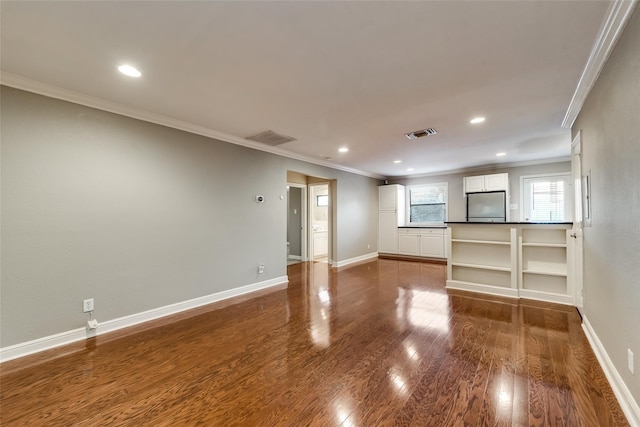 unfurnished living room featuring ornamental molding and dark hardwood / wood-style floors