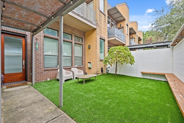 view of yard with a balcony