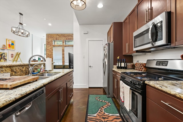 kitchen featuring light stone counters, stainless steel appliances, decorative light fixtures, sink, and a notable chandelier