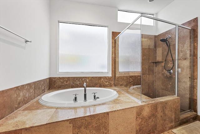 bathroom featuring separate shower and tub