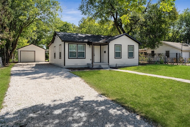 view of front of home featuring an outdoor structure, a garage, and a front yard