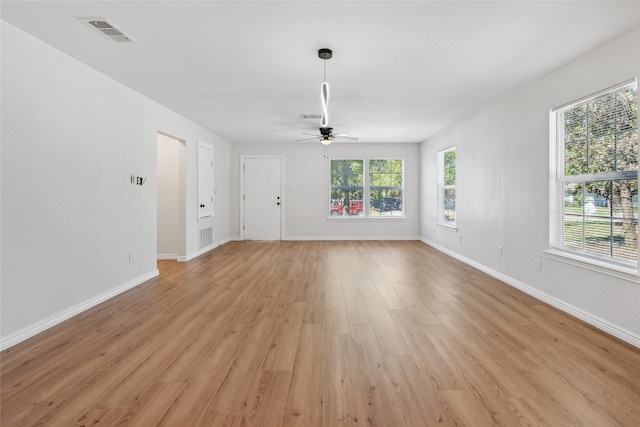 unfurnished living room featuring ceiling fan and light hardwood / wood-style flooring