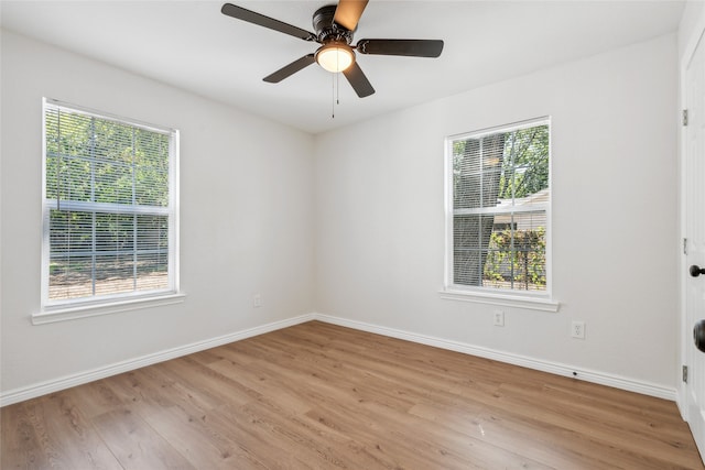 unfurnished room with light hardwood / wood-style floors, ceiling fan, and plenty of natural light