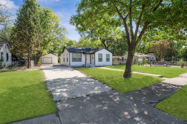 view of front facade featuring an outbuilding, a garage, and a front yard