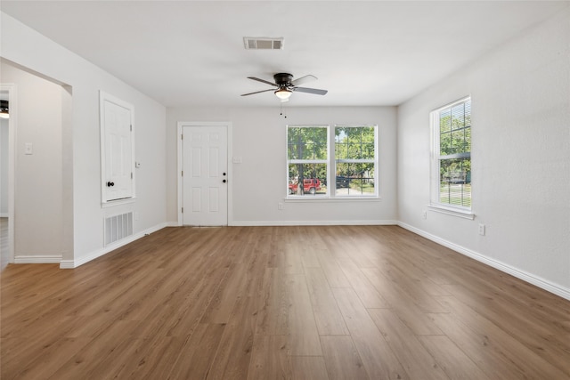 empty room featuring wood-type flooring and ceiling fan