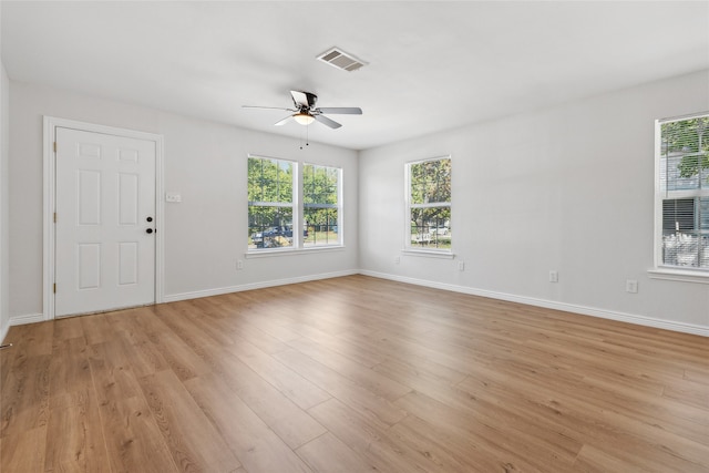 spare room with light wood-type flooring and ceiling fan