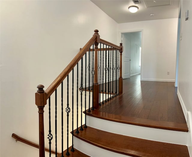 stairs featuring hardwood / wood-style flooring