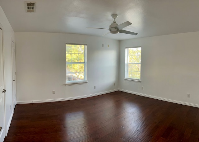 spare room with dark hardwood / wood-style flooring and ceiling fan