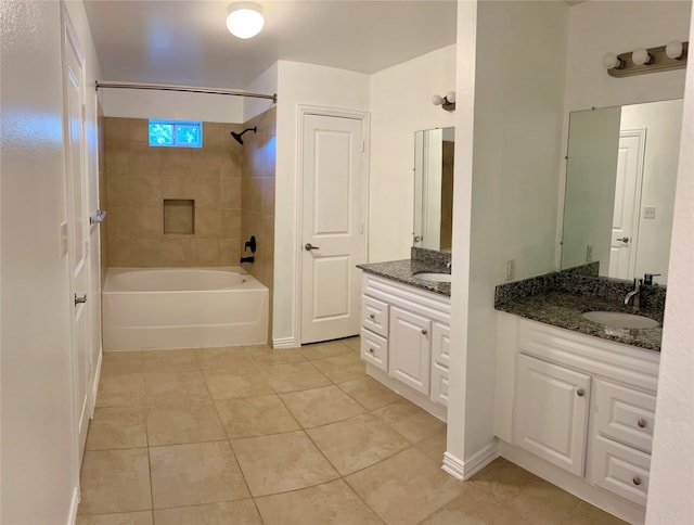 bathroom featuring tiled shower / bath combo, tile patterned flooring, and vanity