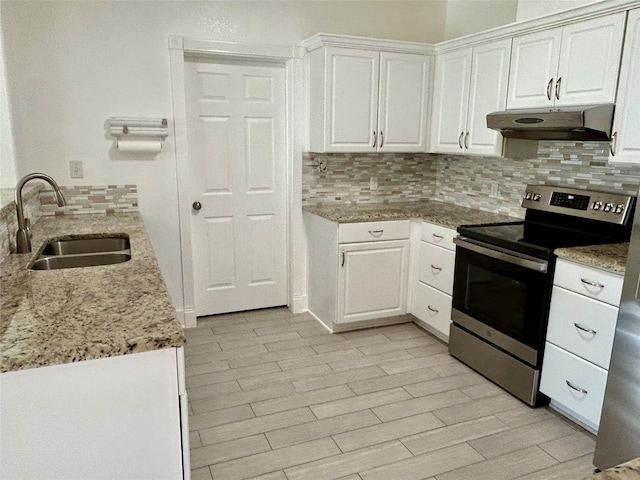 kitchen featuring decorative backsplash, white cabinetry, stainless steel electric range, light stone counters, and sink