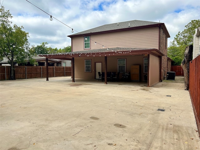 rear view of property with cooling unit and a patio area