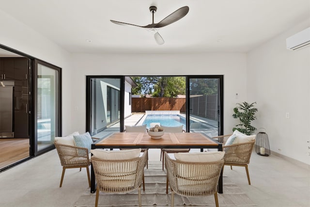 dining space featuring a wall unit AC and ceiling fan