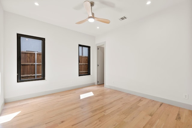 spare room featuring light hardwood / wood-style floors and ceiling fan