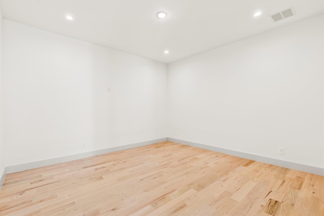 spare room featuring light hardwood / wood-style floors