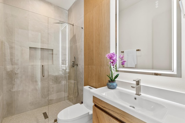 bathroom with vanity, toilet, and an enclosed shower