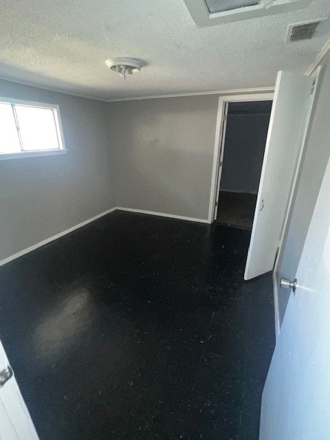 empty room featuring a textured ceiling