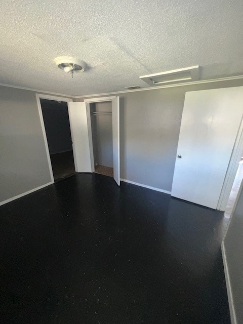 unfurnished room with a textured ceiling