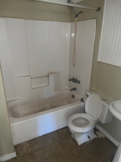 bathroom featuring tile patterned flooring, shower / bath combination, and toilet