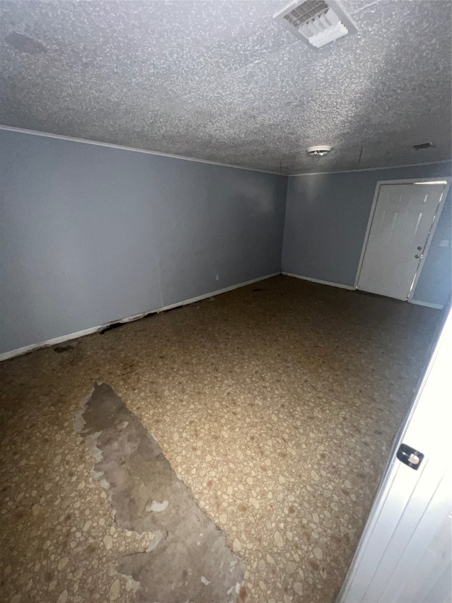 spare room with a textured ceiling