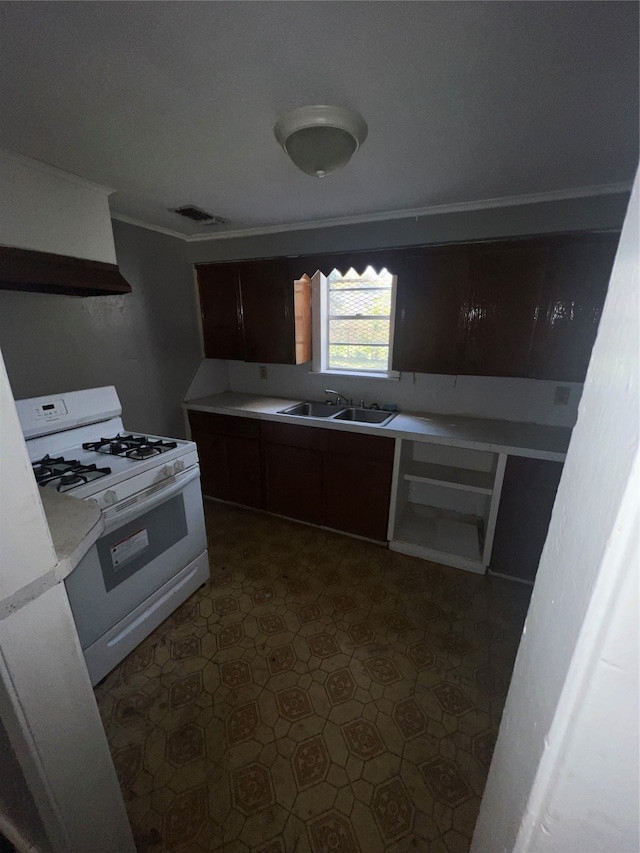 kitchen with extractor fan, sink, white gas range oven, dark brown cabinets, and crown molding