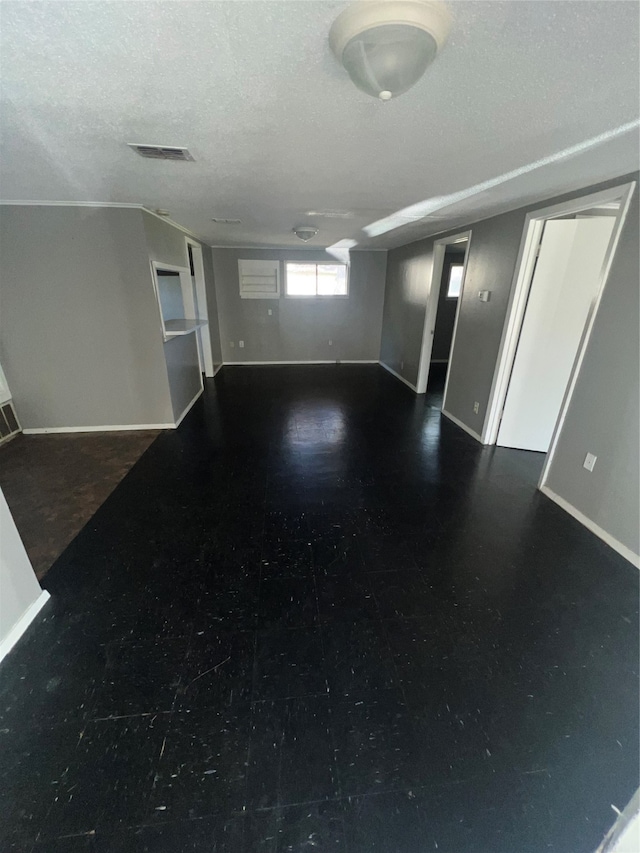 unfurnished living room featuring a textured ceiling