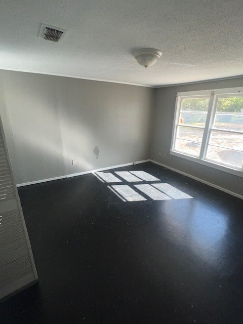 empty room featuring a textured ceiling