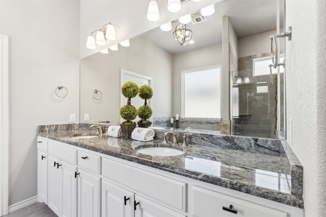 bathroom featuring vanity and an enclosed shower