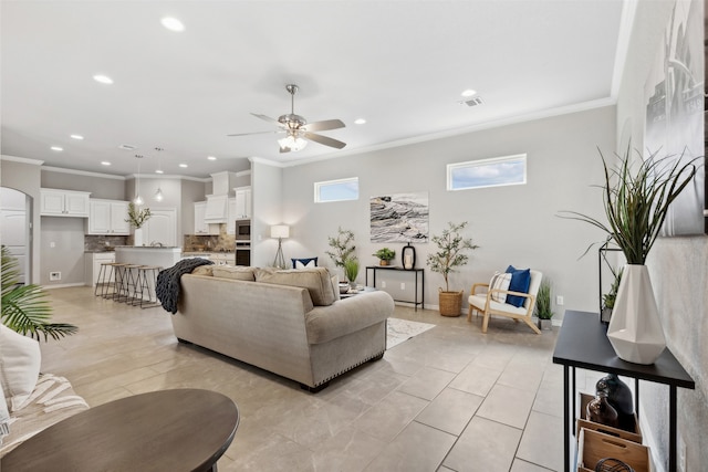 tiled living room featuring ceiling fan and ornamental molding