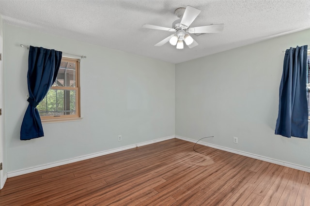 spare room featuring a textured ceiling, hardwood / wood-style floors, and ceiling fan