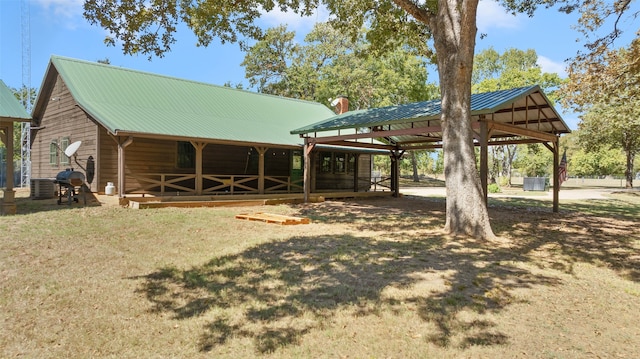 rear view of property with central AC