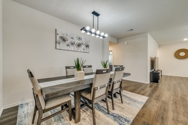 dining room with a notable chandelier and hardwood / wood-style flooring